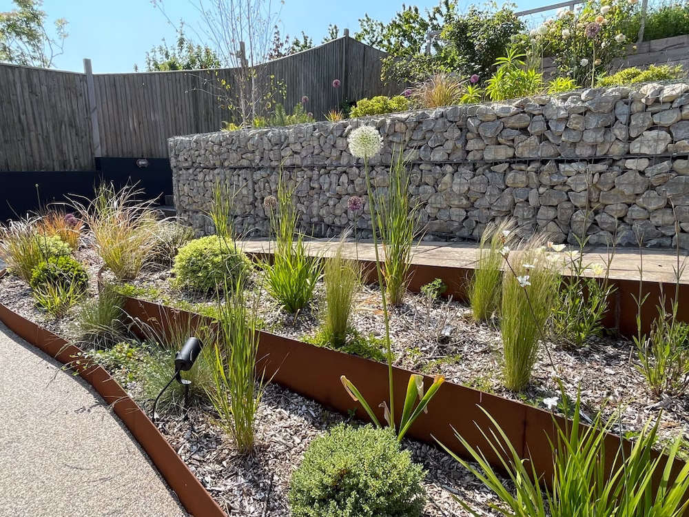 A clean, tiered garden made with corten steel edging