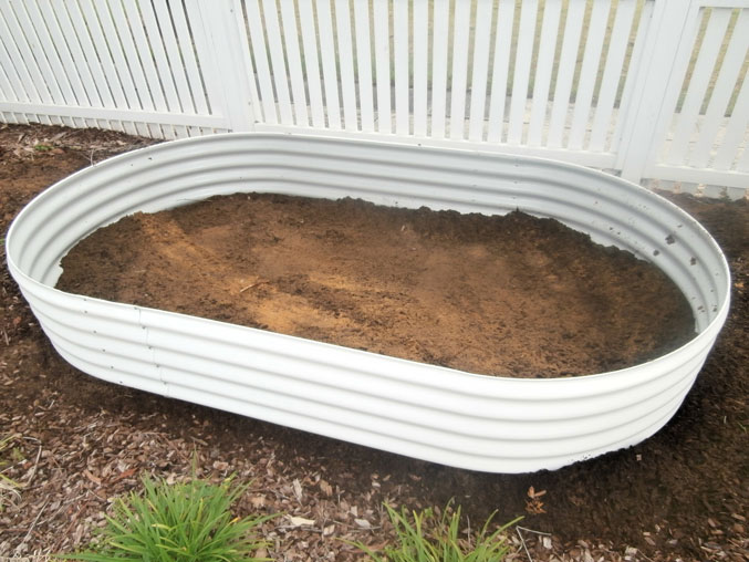 Corrugated steel container converted into a self-wicking raised garden bed