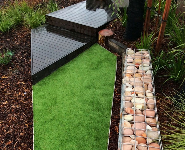 Steel edging used to create a sharp drop between lawn level and a lower garden bed