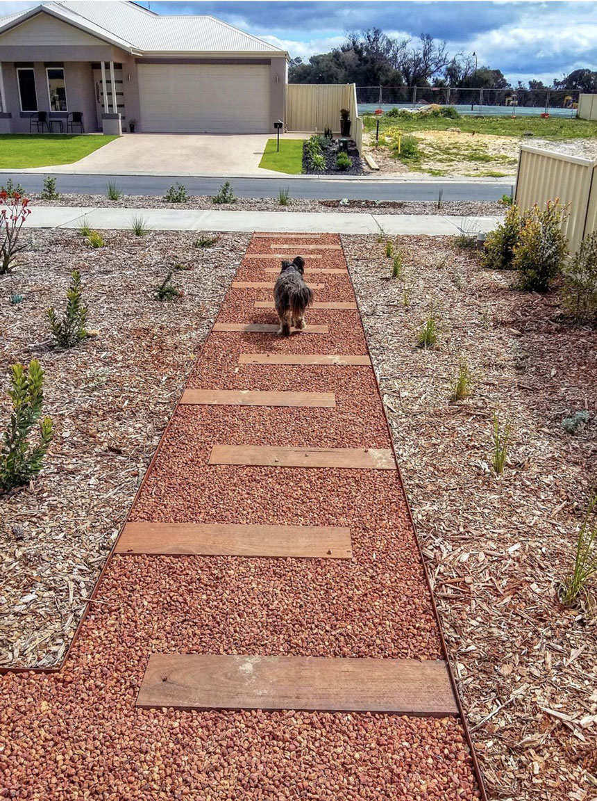 Steel garden edging defining a pathway border, a technique that creates a clean, navigable garden layout