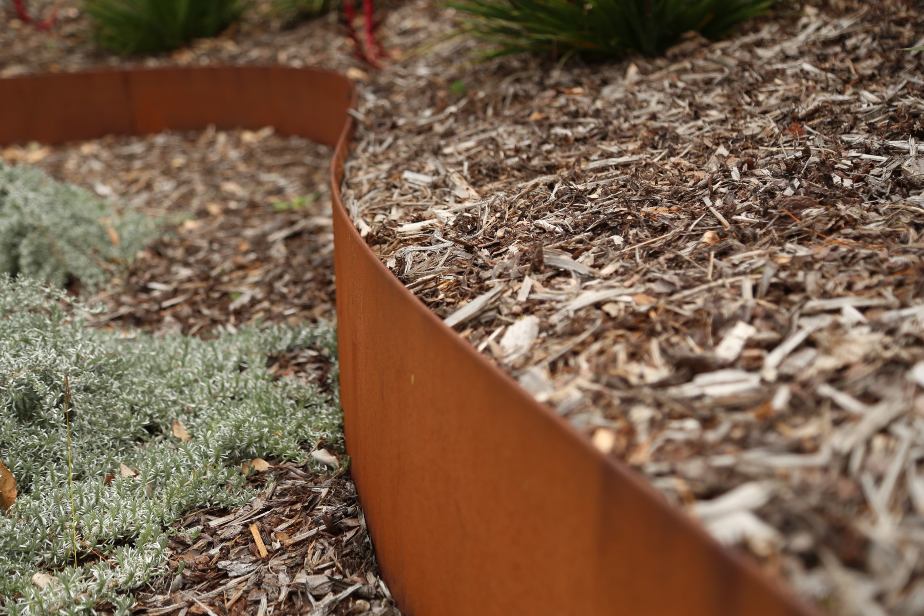 Steel garden edging installed by The Gourmet Landscaper, professional-grade installation that requires minimal maintenance over time