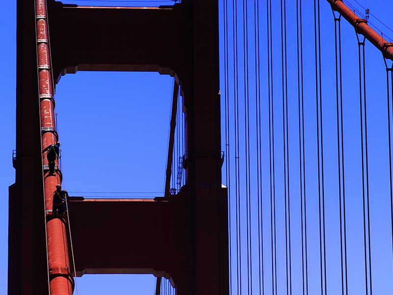 Painter working on a steel bridge, weathering steel was developed to eliminate the need for continuous repainting of large structures